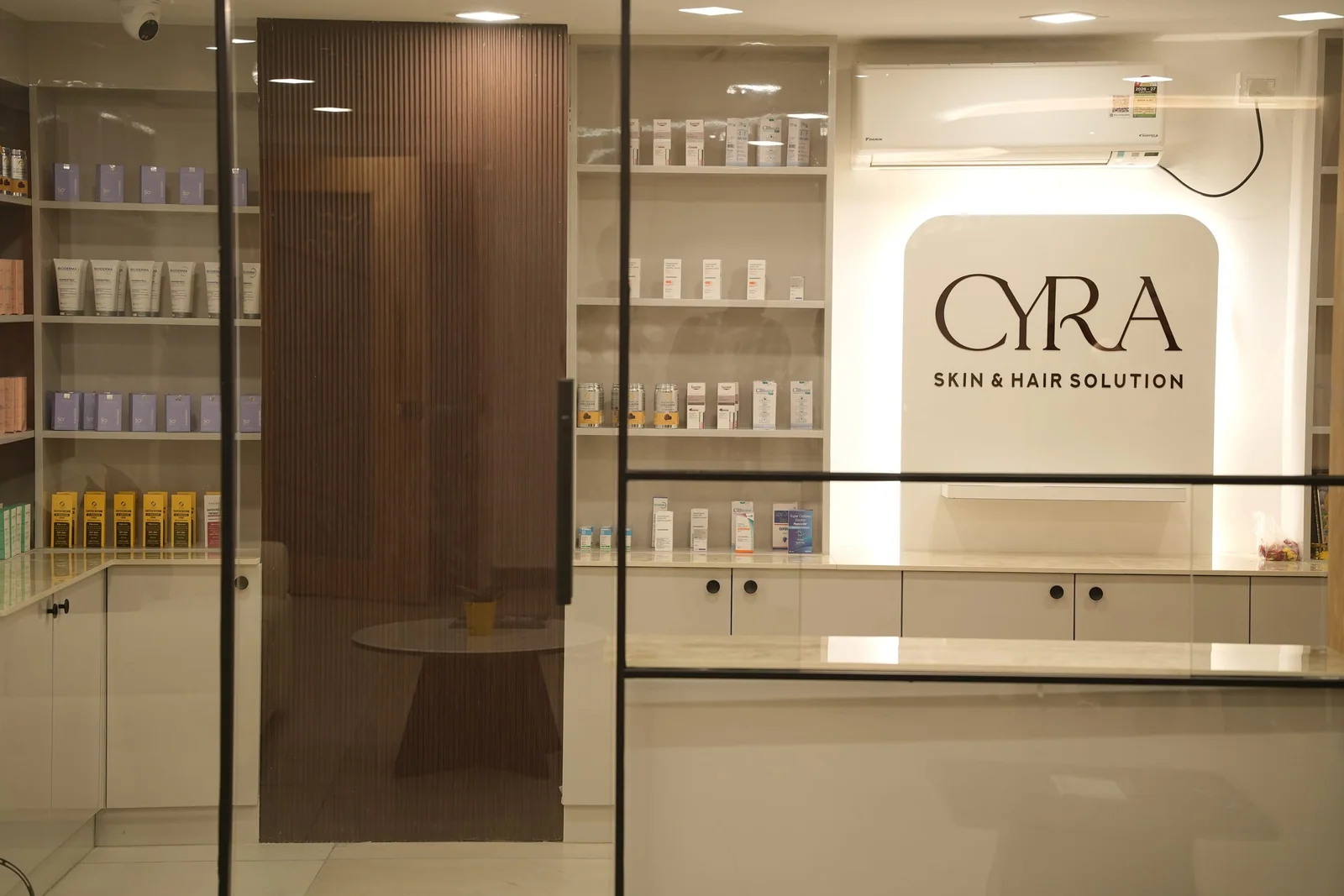 The reception and retail area with the Cyra logo lit on the wall