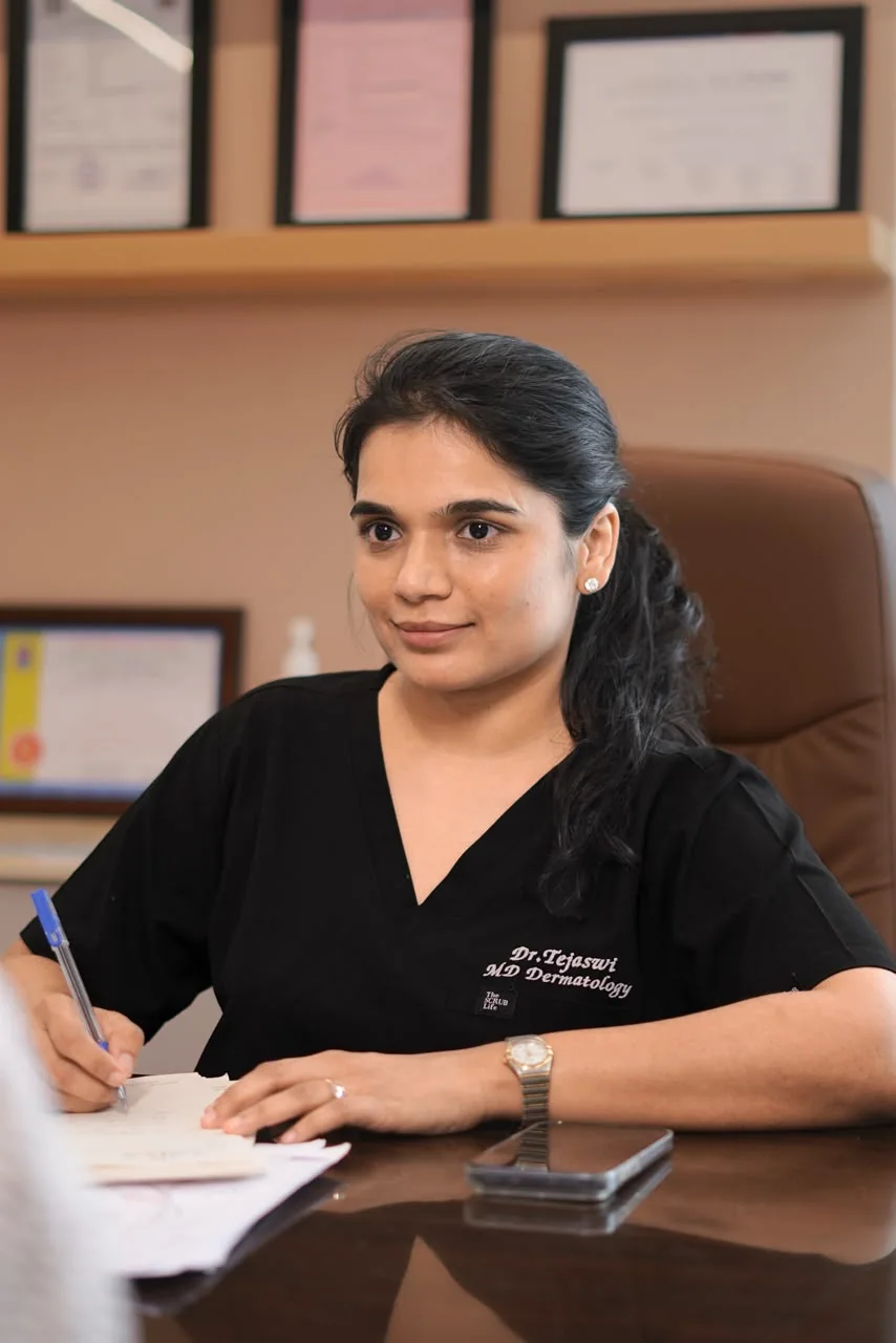 Dr. Tejaswi Kothapally writing notes during a consultation